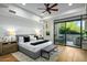 Bright bedroom with a ceiling fan, ensuite bathroom, and a sliding glass door to the outside at 39493 N 107Th Way, Scottsdale, AZ 85262