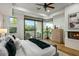 Bright primary bedroom with a modern fireplace and sliding glass doors to the outside at 39493 N 107Th Way, Scottsdale, AZ 85262