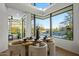 Modern dining room with large windows, backyard views and a contemporary table setting at 39493 N 107Th Way, Scottsdale, AZ 85262