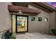 Contemporary home entrance featuring a black-framed glass door, desert landscaping, and modern design at 39493 N 107Th Way, Scottsdale, AZ 85262