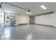 A spacious garage with epoxy floors, ample storage cabinets, and overhead lighting for organization at 39493 N 107Th Way, Scottsdale, AZ 85262