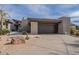 Modern home featuring desert landscaping, a concrete driveway, and a two car garage at 39493 N 107Th Way, Scottsdale, AZ 85262