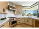 Bright kitchen with stainless steel Wolf range, custom cabinets, and white marble countertops at 39493 N 107Th Way, Scottsdale, AZ 85262