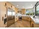 Open kitchen with modern appliances, custom wood cabinets, and a large picture window at 39493 N 107Th Way, Scottsdale, AZ 85262