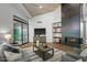 Living room with modern furnishings, a fireplace, and a sliding glass door leading to an outdoor patio at 39493 N 107Th Way, Scottsdale, AZ 85262