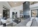 Spacious living room featuring a fireplace, high ceilings, modern furnishings, and ample natural light at 39493 N 107Th Way, Scottsdale, AZ 85262