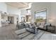 Bright living room featuring high ceilings, modern furnishings, and large windows with natural light at 39493 N 107Th Way, Scottsdale, AZ 85262