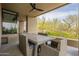 Cozy covered patio with a dining table, offering picturesque views of the surrounding landscape at 39493 N 107Th Way, Scottsdale, AZ 85262