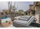 Relaxing poolside lounge area with stylish chairs, desert landscaping, and swimming pool at 39493 N 107Th Way, Scottsdale, AZ 85262