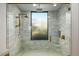 Large walk-in shower features gray subway tile, rainfall shower head, handheld sprayer, and a window at 39493 N 107Th Way, Scottsdale, AZ 85262