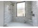 Modern glass-enclosed shower with sleek fixtures and bright tilework creates a refreshing and stylish bathing experience at 39493 N 107Th Way, Scottsdale, AZ 85262