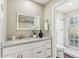 Modern bathroom with a marble vanity and a glass-block shower at 4726 E Grandview Rd, Phoenix, AZ 85032