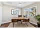 Bright home office features a wood desk, window, and hardwood floors at 4726 E Grandview Rd, Phoenix, AZ 85032