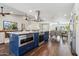 Modern kitchen with blue island, stainless steel appliances, and white cabinets at 4726 E Grandview Rd, Phoenix, AZ 85032