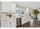 White kitchen cabinets and a large island with marble countertops at 4726 E Grandview Rd, Phoenix, AZ 85032