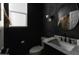 Modern bathroom with dark walls and marble vanity at 4831 S Molly --, Mesa, AZ 85212