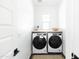 Bright laundry room with washer, dryer, and built-in shelving at 4831 S Molly --, Mesa, AZ 85212