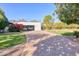 Paver driveway leads to a modern home with glass garage doors and manicured landscaping at 5203 N Monte Vista Dr, Paradise Valley, AZ 85253