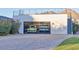 Spacious garage with glass door and two trucks parked inside, featuring a brick driveway at 5203 N Monte Vista Dr, Paradise Valley, AZ 85253