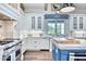 Kitchen showcasing stainless steel stove, stylish backsplash, white cabinets, and an island at 5203 N Monte Vista Dr, Paradise Valley, AZ 85253