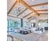 Elegant living room featuring exposed beams, chandeliers, comfortable seating, and a neutral color palette at 5203 N Monte Vista Dr, Paradise Valley, AZ 85253