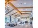 Spacious living room with high ceilings, exposed wood beams, chandeliers, and an open-concept design at 5203 N Monte Vista Dr, Paradise Valley, AZ 85253