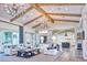 Spacious living room featuring exposed wood beams, elegant chandeliers, and an open floor plan at 5203 N Monte Vista Dr, Paradise Valley, AZ 85253