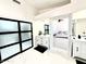 A modern bathroom features marble floors and countertops, and vanity, and access to the bedroom at 5748 W Soft Wind Dr, Glendale, AZ 85310