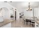 Kitchen dining area with chandelier and view to living room and pantry at 5748 W Soft Wind Dr, Glendale, AZ 85310