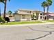 Inviting home with lush landscaping, a desert motif, and a well-manicured lawn at 5748 W Soft Wind Dr, Glendale, AZ 85310