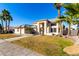 Two-story house with a spacious front yard and palm trees at 5748 W Soft Wind Dr, Glendale, AZ 85310