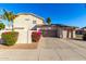 Two-car garage with landscaping and a gated entrance at 5748 W Soft Wind Dr, Glendale, AZ 85310