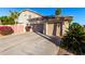 Two-car garage with driveway and landscaping at 5748 W Soft Wind Dr, Glendale, AZ 85310