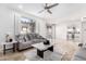 Spacious Gathering room with gray sofas, a large window, and kitchen access at 5748 W Soft Wind Dr, Glendale, AZ 85310