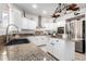 Modern kitchen with granite countertops, stainless steel appliances, and white cabinets at 5748 W Soft Wind Dr, Glendale, AZ 85310