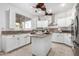 Spacious kitchen with island, granite countertops, stainless steel appliances, and white cabinets at 5748 W Soft Wind Dr, Glendale, AZ 85310