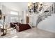 Open living room with high ceilings, a grand staircase, and lots of natural light at 5748 W Soft Wind Dr, Glendale, AZ 85310