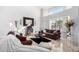 Living room featuring leather sofas and a large mirror at 5748 W Soft Wind Dr, Glendale, AZ 85310