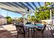 Pergola-covered patio with seating area overlooking the pool at 5748 W Soft Wind Dr, Glendale, AZ 85310