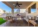 Relaxing covered patio with seating area and outdoor kitchen at 5748 W Soft Wind Dr, Glendale, AZ 85310