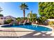 Curved pool with rock waterfall and spacious deck area at 5748 W Soft Wind Dr, Glendale, AZ 85310