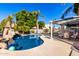 Stunning kidney shaped pool with a pergola and patio furniture at 5748 W Soft Wind Dr, Glendale, AZ 85310