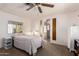 Cozy bedroom with ceiling fan and en-suite bathroom access at 6960 W Peoria Ave # 171, Peoria, AZ 85345