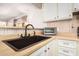 Modern kitchen sink with sleek faucet and white cabinetry at 6960 W Peoria Ave # 171, Peoria, AZ 85345