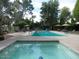 Community pool and spa with lounge chairs and umbrellas at 6960 W Peoria Ave # 171, Peoria, AZ 85345