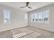 Bright bedroom with window shutters and ceiling fan at 755 E Zion Dr # 103, Gilbert, AZ 85297