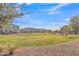 Community greenbelt with grassy area and homes in background at 755 E Zion Dr # 103, Gilbert, AZ 85297