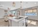 Kitchen island with white cabinets and a farmhouse sink, open to living area at 755 E Zion Dr # 103, Gilbert, AZ 85297