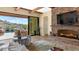 Bright living room with a stone fireplace and view of the backyard oasis at 7575 E Camino Salida Del Sol --, Scottsdale, AZ 85266