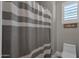 Clean bathroom with shower and striped curtain at 8308 W Avenida Del Sol --, Peoria, AZ 85383